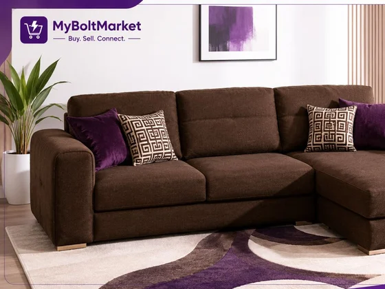 A brown corner sofa with cushions in a styled living room